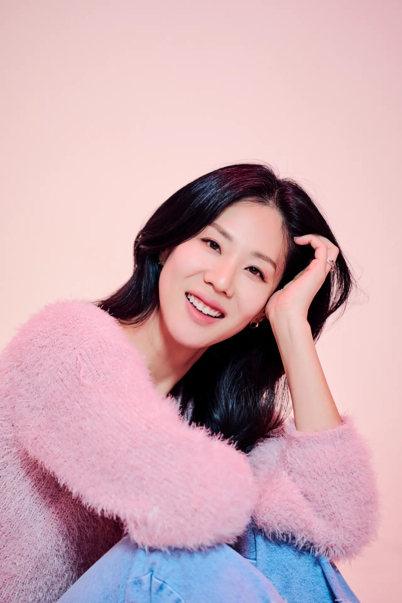 Michelle Jean Kim smiling in a pink knit sweater
